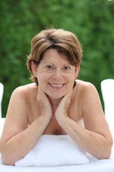 Closeup of senior woman relaxing on massage bed