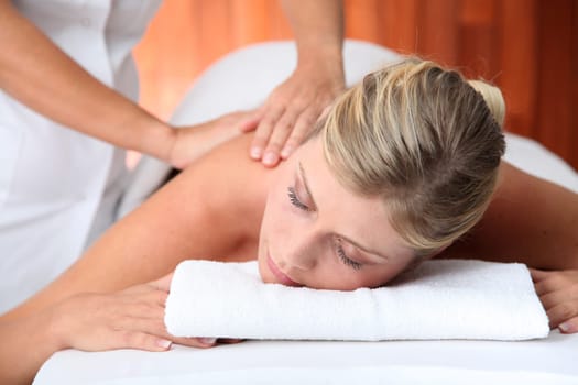 Closeup of beautiful woman laying on a massage bed