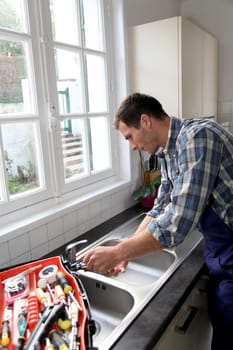 Plumber fixing domestic sink