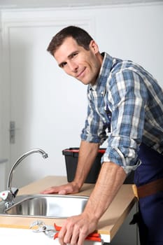 Plumber fixing domestic sink