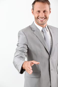 Businessman extending hand towards camera