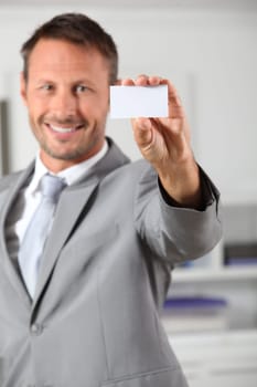 Businessman holding business card