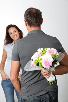 Man giving bunch of flowers to girlfriends