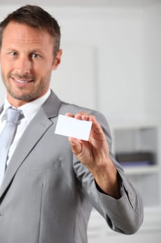 Businessman holding business card