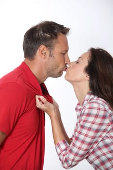 Closeup of in loved couple kissing on white background