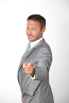 Businessman pointing at camera