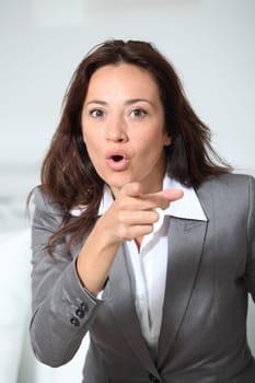 Businesswoman pointing at camera