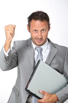 Businessman with laptop computer lifting arm up