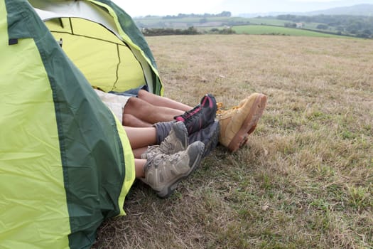 View of people feet from outside a camp tent
