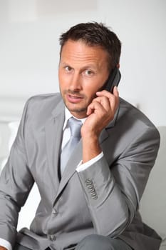 Closeup of businessman talking on mobile phone