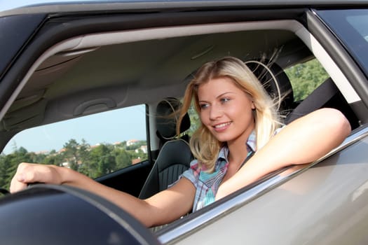 Young woman driving new car