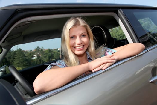 Young woman driving new car