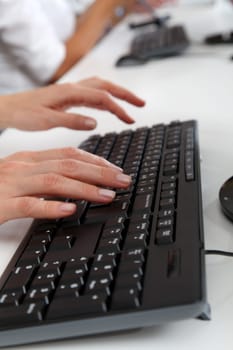 Closeup of hands on computer keyboard