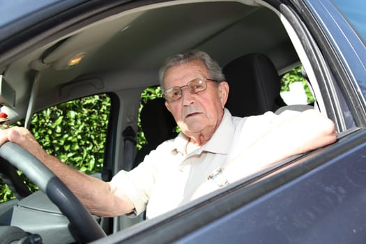 Elderly person driving a car