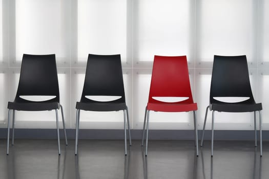 Fours chairs in line againt wall