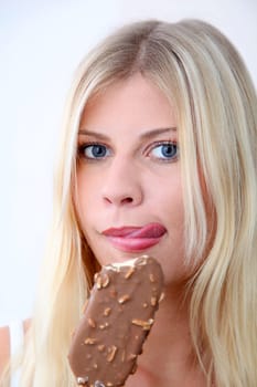 Closeup of beautiful blond woman eating ice cream