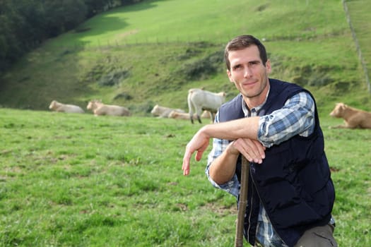 Breeder standing in pasture land