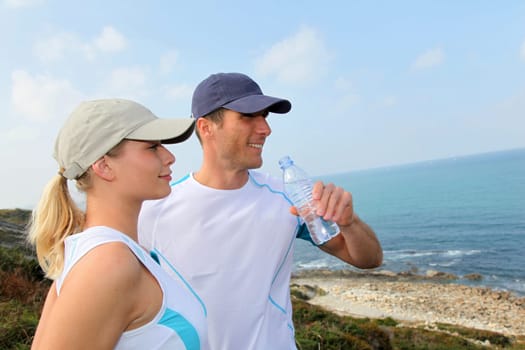 Couple drinking water after exercising