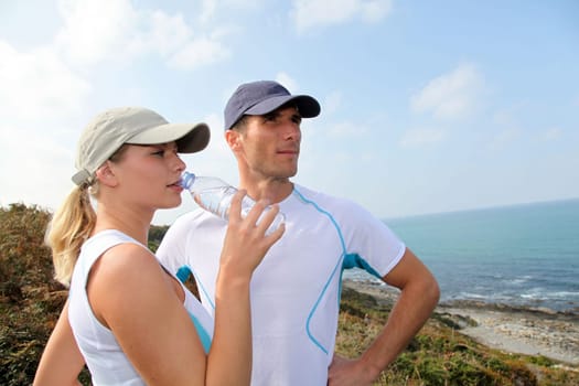 Couple drinking water after exercising