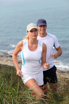 Couple running outside on a sunny day