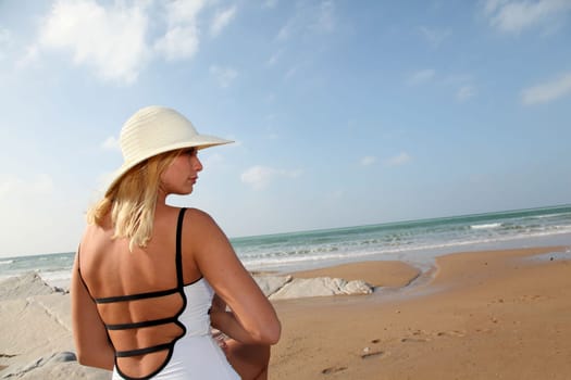Woman sitting on a sandy beach