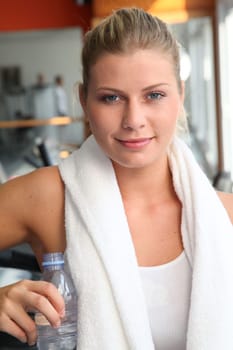 Woman drinking water after exercising