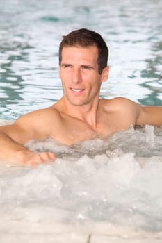 Man bathing in jacuzzi of spa center