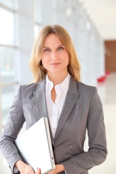 Closeup of blond businesswoman standing in hall