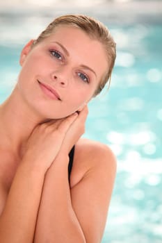 Beautiful woman sitting in swimsuit in spa resort
