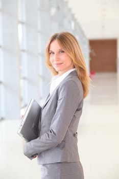 Closeup of blond businesswoman standing in hall