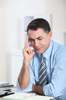 Businessman in the office working hard on project