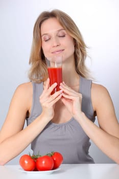 Woman drinking tomato juice