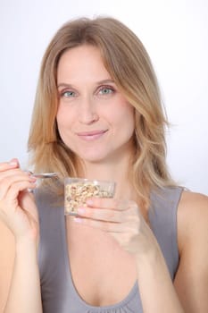 Closeup of beautiful blond woman eating cereals