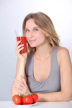 Woman drinking tomato juice