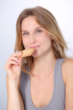 Closeup of woman eating cookie