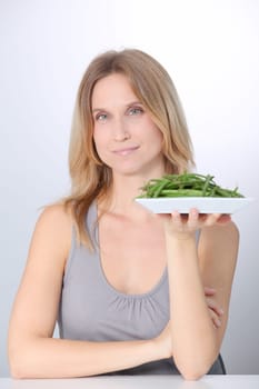 Woman in front of plate of green beans