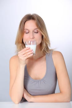 Closeup of beautiful woman drinking milk