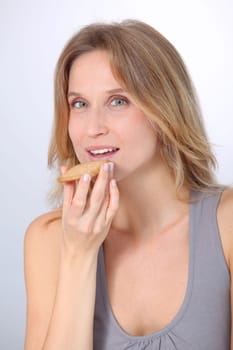 Closeup of woman eating cookie