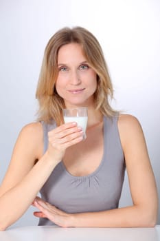 Closeup of beautiful woman drinking milk