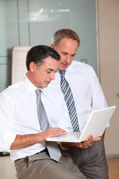 Salesmen meeting in the office with laptop