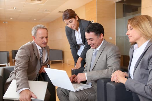 Group of associates meeting in lounge