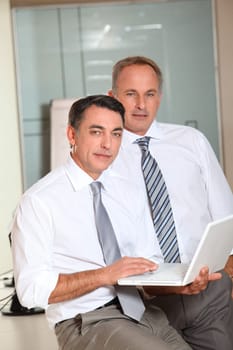 Salesmen meeting in the office with laptop