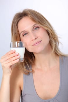 Closeup of beautiful woman drinking milk