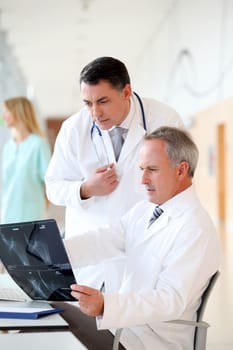 Doctors looking at radiography in hospital