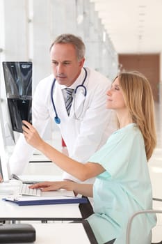 Doctor and nurse looking at x-ray