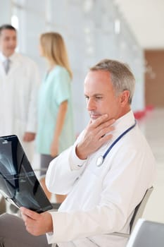 Doctor looking at xray with worried look
