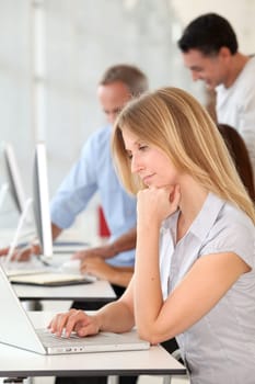 Beautiful woman working in the office on laptop computer