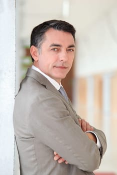 Portrait of businessman standing in hall