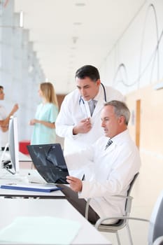 Doctors looking at radiography in hospital