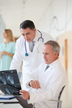 Doctors looking at radiography in hospital